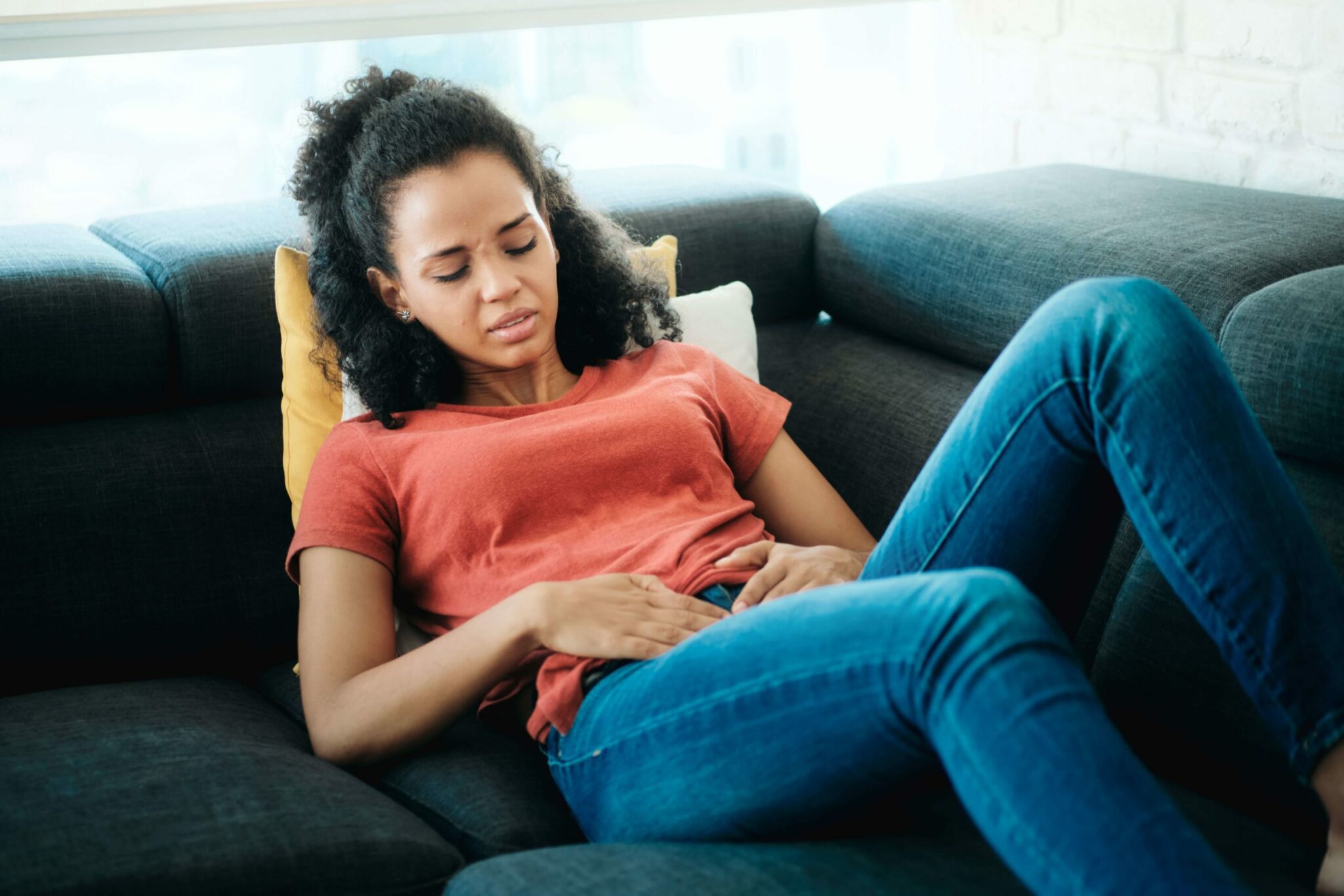 women laying on bed due to abnormal uterine bleeding cmp