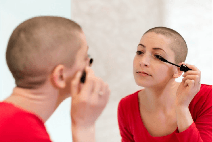 A lady applying mascara
