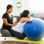 A pregnant woman getting massages from a doula